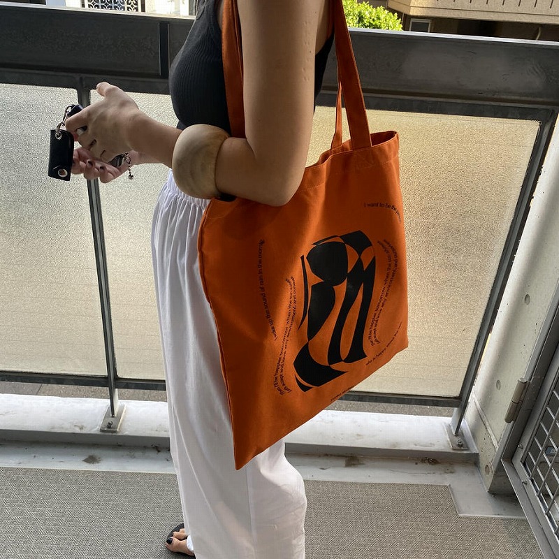 LIGHT IS WORN BRADY ORANGE TOTE BAG